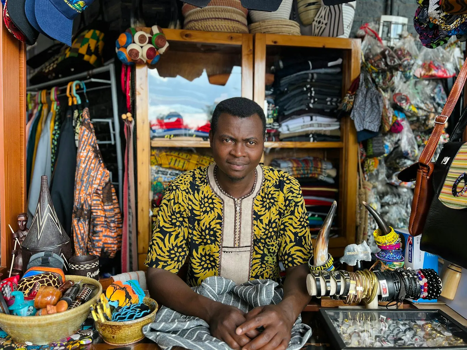 A trader in his fabric and goods stall